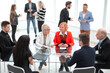 © ASDF - Business people sitting around the desk in a meeting and making