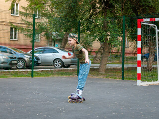 boy having fun rollerblading on the playground