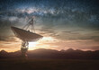 © ktsdesign - Huge satellite antenna dish for communication and signal reception out of the planet Earth. Observatory searching for radio signal in space at sunset.