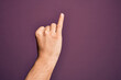 © Krakenimages.com - Hand of caucasian young man showing fingers over isolated purple background showing little finger as pinky promise commitment, number one