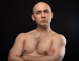 Wall Mural - Photo of bald serious man with bare shoulders