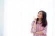 © NT_studio - Portrait young asian woman think idea and inspiration in imagine with expressive, happy female teenage expression with presenting on curtain white background, creativity and dream, lifestyle concept.