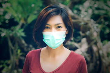 Portrait young asian woman in face mask, protection covid-19 epidemic, protective pandemic of disease coronavirus or flu, female safety for virus and respiratory, medical and health concept.