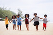 © chayantorn - Funny vacation. Children or kids playing and romp together at the beach on holiday. Having fun after unlocking down the city from COVID19. Seven African American kids. Ethnically diverse concept