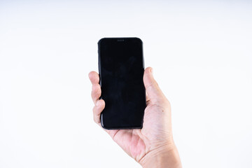 Isolated shot of a man's hand holding a mobile phone