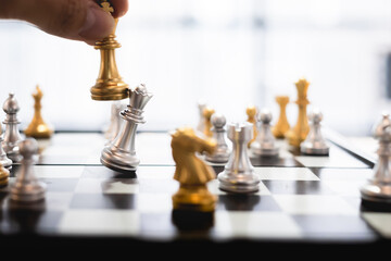 Leading strategy of successful business leader, hand on business moving chess in competition to success