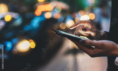 Fotografía Businesswoman with smartphone using application for calling taxi online walking