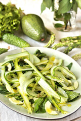 Wall Mural - salad of asparagus and cucumber shavings and spinach, thin slices of vegetables with olive oil