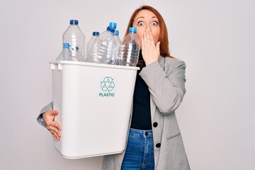 Sticker - Young beautiful redhead woman recycling holding trash can with plastic bottles to recycle cover mouth with hand shocked with shame for mistake, expression of fear, scared in silence, secret concept