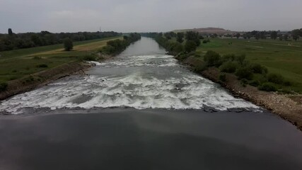 Canvas Print - Strong current on Sava river, Zagreb, under rainy, cloudy sky, filmed with drone