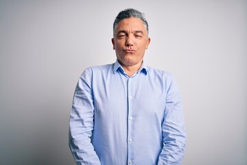 Poster - Middle age handsome grey-haired business man wearing elegant shirt over white background making fish face with lips, crazy and comical gesture. Funny expression.