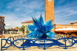 Famous glass sculpture and tower with nice blue sky at Murano island near Venice Italy