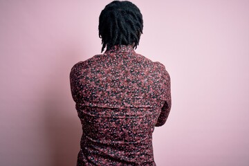 Sticker - Young handsome african american man wearing casual shirt standing over pink background standing backwards looking away with crossed arms