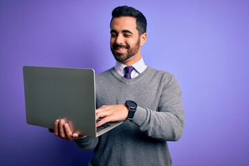 Poster - Young handsome businessman with beard working using laptop over purple background with a happy face standing and smiling with a confident smile showing teeth