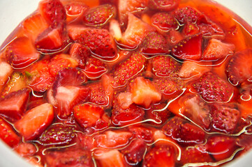 sliced ​​strawberries with syrup. glare of light