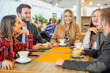 Friends hanging  with each other in bar and having fun together - Students drinking having conversation smiley and happy being around outside 