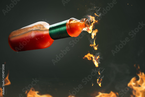 Burning hot chili sauce dripping from a bottle Poster Mural XXL