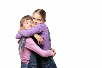 Wall Mural - Two girlfriends happily hug each other, white background