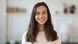 © fizkes - Close up headshot portrait of smiling young caucasian woman look at camera posing in new own home, happy millennial female renter or tenant feel optimistic positive, moving in or relocating