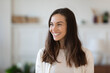 © fizkes - Happy young caucasian woman look in window distance thinking or dreaming, smiling optimistic millennial female renter feel overjoyed excited moving to new home, visualizing or imagining indoors