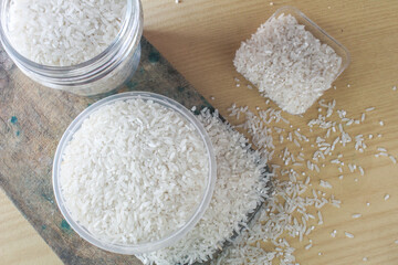 Raw white rice on the table, wood background