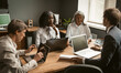 © Svyatoslav Lypynskyy - Brainstorming of Diverse group employees working together on a new business project. Young African girl, an elderly gray-haired Asian woman and two Caucasian young men share their ideas.