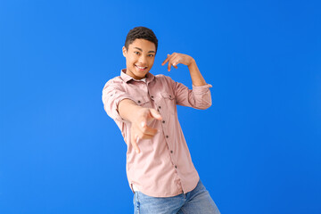 Poster - African-American teenager dancing against color background