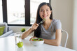 © Pormezz - Beauty young asian brunette woman eat salad as a breakfast.
