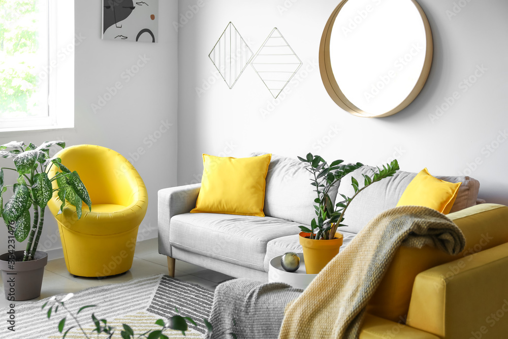Stylish interior of living room with mirror and sofa