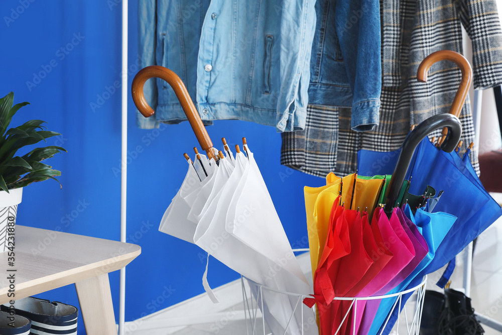 Stylish umbrellas in interior of hall