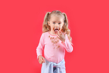 Wall Mural - Little girl with chocolate stains on her clothes against color background