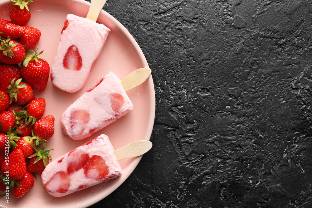Plate with tasty strawberry ice cream on dark background