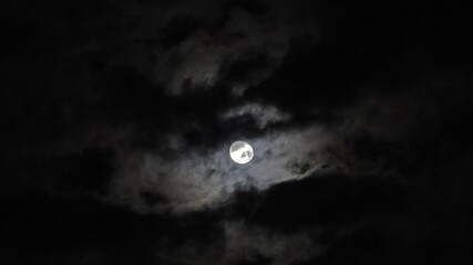 Wall Mural - full moon moving between clouds, 4k