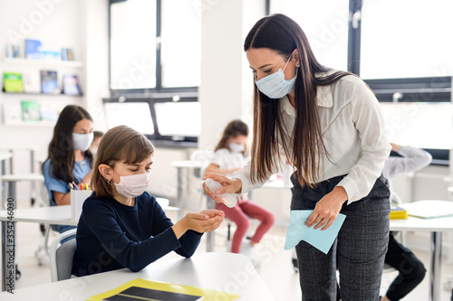 Cuadros en Lienzo Teacher, children with face mask at school after covid-19 quarantine and lockdown