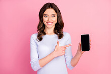 Photo Of Beautiful Lady Hold Telephone Hands Directing Finger Touch Screen Advising Amazing Renew Interface Model Sale Manager Wear Casual White Shirt Isolated Pastel Pink Color Background
