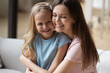 © fizkes - Happy young mother hug cute little daughter enjoying tender family moment at home together, smiling mom embrace small preschooler girl child show love and care, bonding, gratitude concept