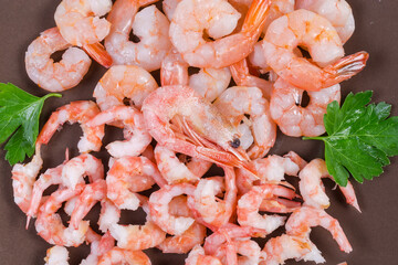 Cooked tails different shrimps on dish, top view close-up