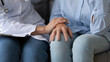 © fizkes - Female nurse touches hand of elderly patient seated on sofa encourages her express empathy show good relation close up image. Concept of healthcare, dementia, senile diseases, disabled person medicare