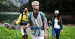 © NDABCREATIVITY - Group of happy hiker friends trekking as part of healthy lifestyle outdoors activity