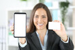 © Antonioguillem - Happy executive shows card and phone at the office