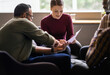 © JonoErasmus - Smiling businesswoman going over paperwork with colleagues during meeting