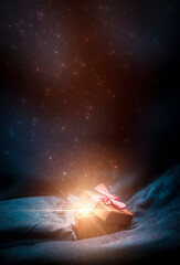 gift box on a dark magic background with light bokeh. festive background, magic box with a gift. dar
