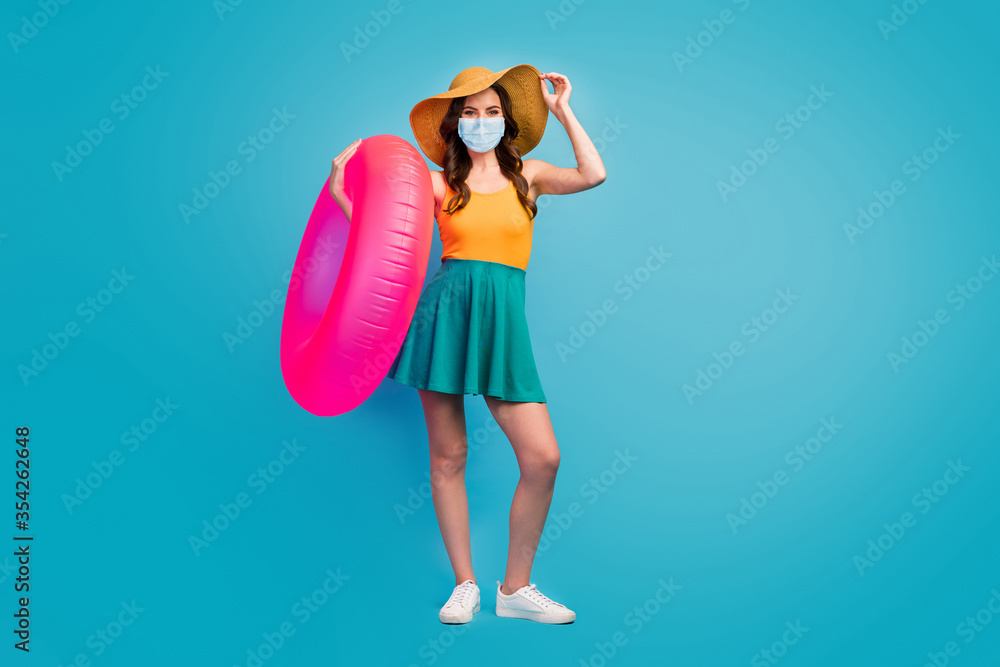 Full length body size view of her she pretty lady hold pink rubber ring wear mask public place social distance visit poolside isolated over bright vivid shine vibrant blue color background - obrazy, fototapety, plakaty 