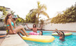 © Alessandro Biascioli - Group happy friends enjoying summer day in swimming pool with inflatable - Young multiracial people having fun in exclusive resort hotel - Youth vacation lifestyle concept