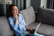 © Drobot Dean - Image of woman talking on mobile phone and using laptop while sitting