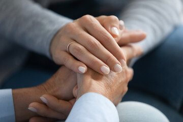 Wall Mural - Close up adult daughter holding mothers hand, gesture symbol of psychological support in difficult period of life, fatal cancer disease, capacity understand feelings sharing of pain, empathy concept