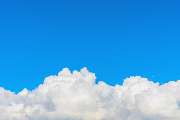 Wall Mural - fluffy cloud against blue sky background for summer and nature concept