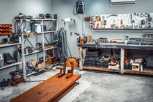 Garage, Service Area For Disassembling, Repairing Motorcycles, Car Service Station. Inside The Workshop With Large Workbench, Shelving, Moto Lift, Tools Kit For Processing Wrenches On The Wall