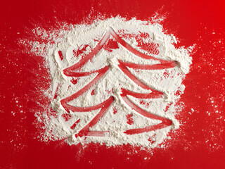 Wall Mural - Christmas tree on flour background. White flour looks like snow. Top view