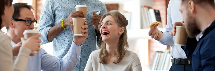 Wall Mural - Group of cheerful friends colleagues during break at work eat pizza drink coffee enjoy communication. Team building activity, corporate party concept. Horizontal photo banner for website header design